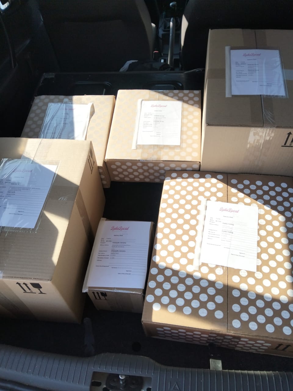 Client parcels loaded in a vehicle for delivery